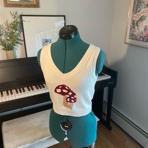 I am selling a red and white mushroom sweater vest